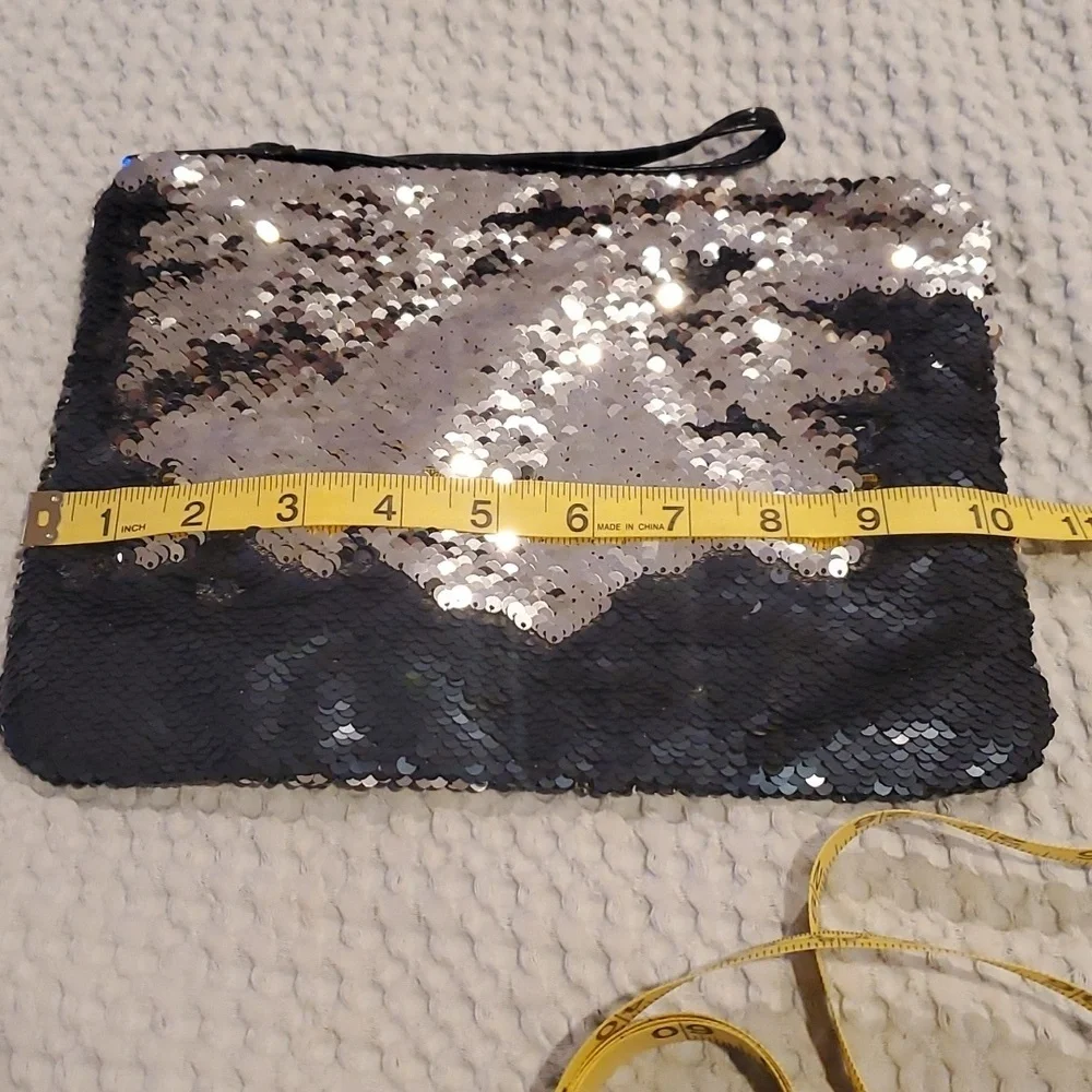 NWOT Cheekys brand color changing sequin wristlet. Changes from silver to black